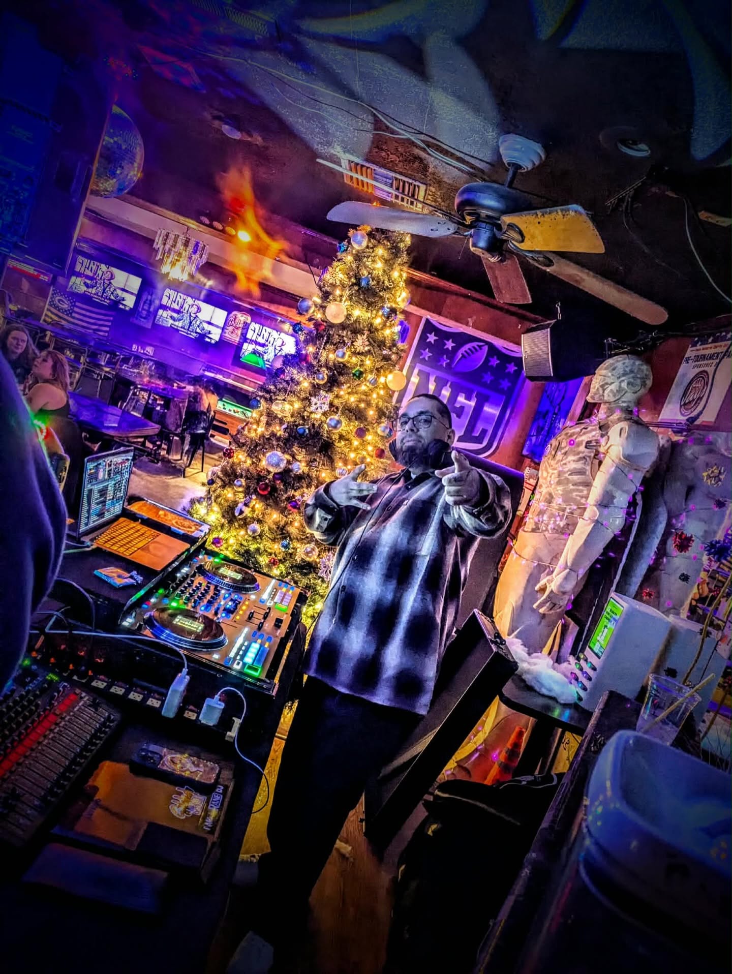 DJ Vic behind the decks in a nightclub